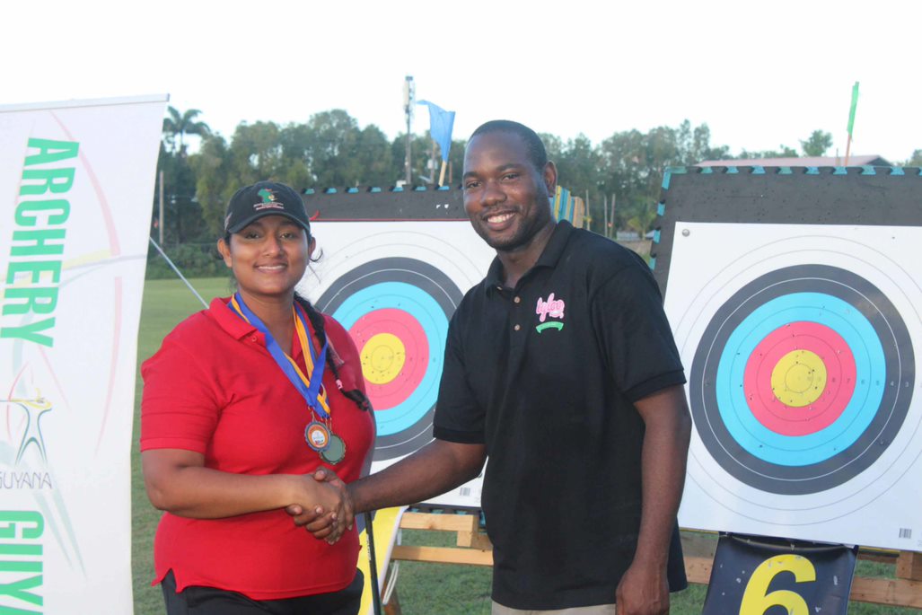 Ms. Roshini Boodhoo-Persaud receiving medal from sponsor, Mr. Dellon Lynch, Marketing Manager of Sterling Products